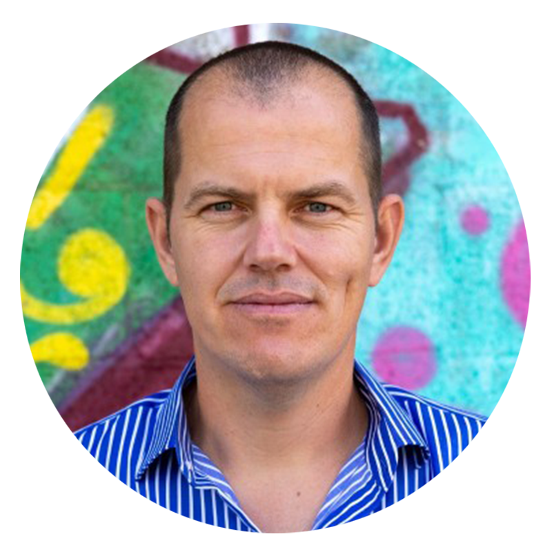 Man in blue striped shirt, colorful background.