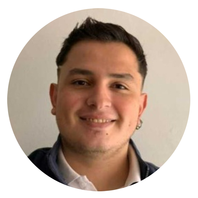 Smiling man with short hair and earrings.